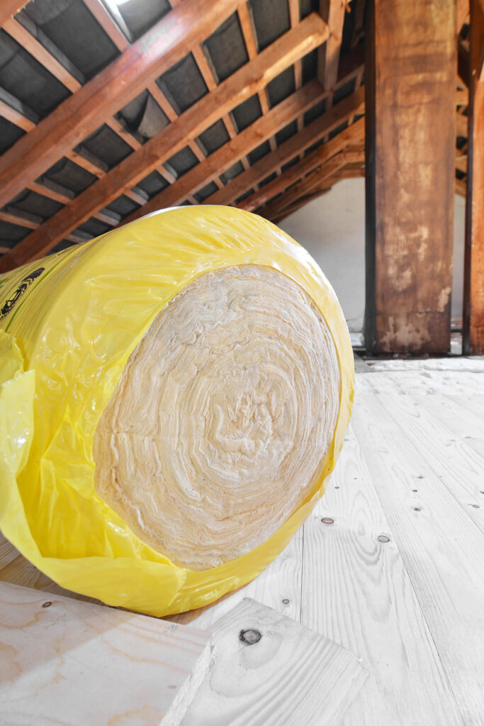 A,Roll,Of,Insulating,Glass,Wool,On,An,Attic,Floor