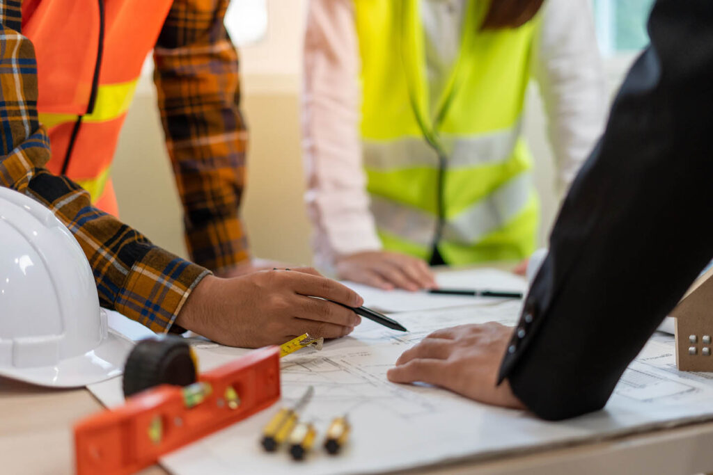 Real,Estate,Agents,And,Construction,Team,Leaders,Work,Together.,View